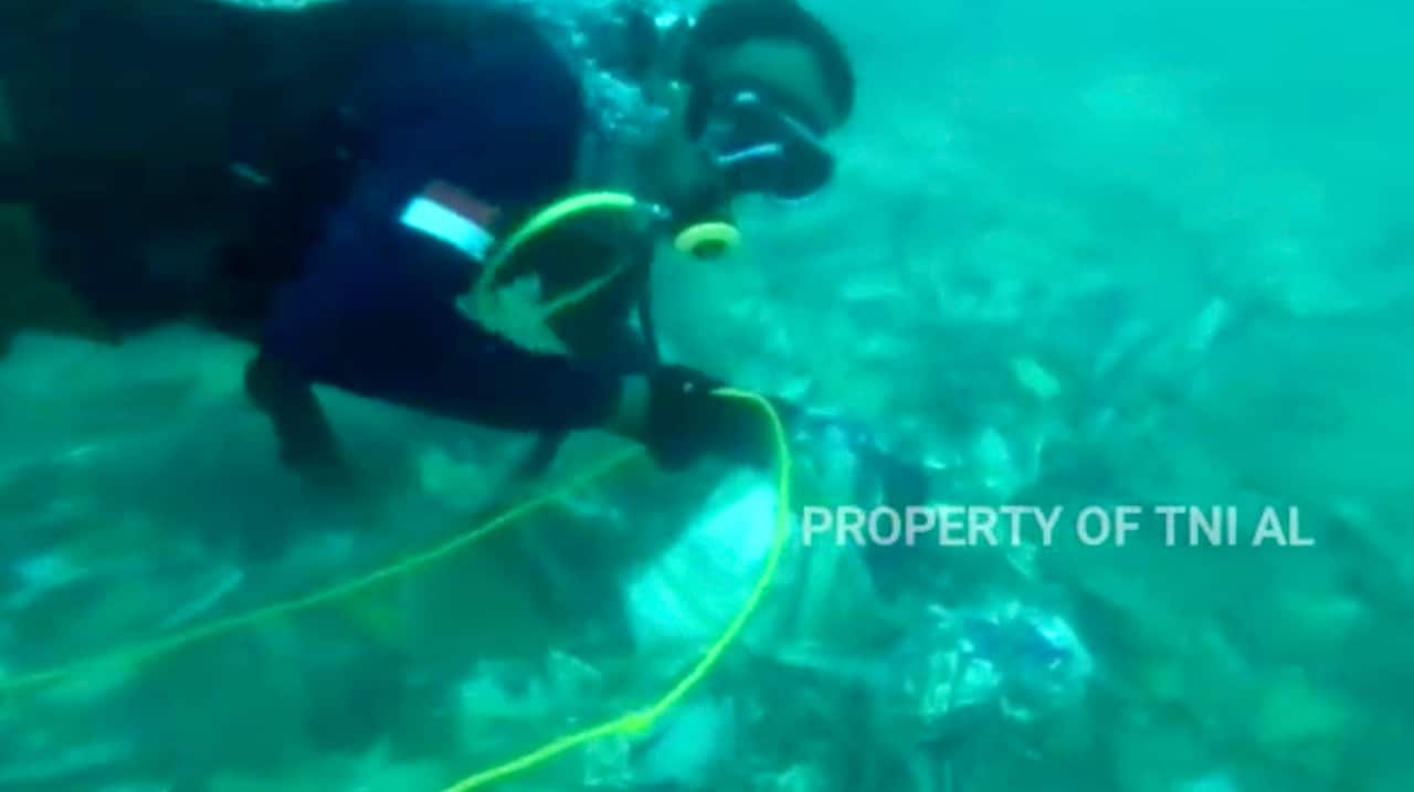 Divers recovering debris strewn on the floor of the Java Sea where Sriwijaya Air passenger jet crashed.