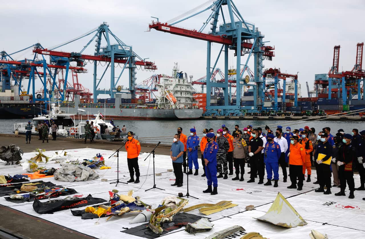 National search and rescuers teams display to the media debris of the Sriwijaya Air flight SJ182, found in the waters off Jakarta.