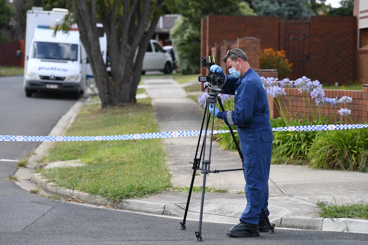 Forensic officers are seen at work at a crime scene in Tullamarine.