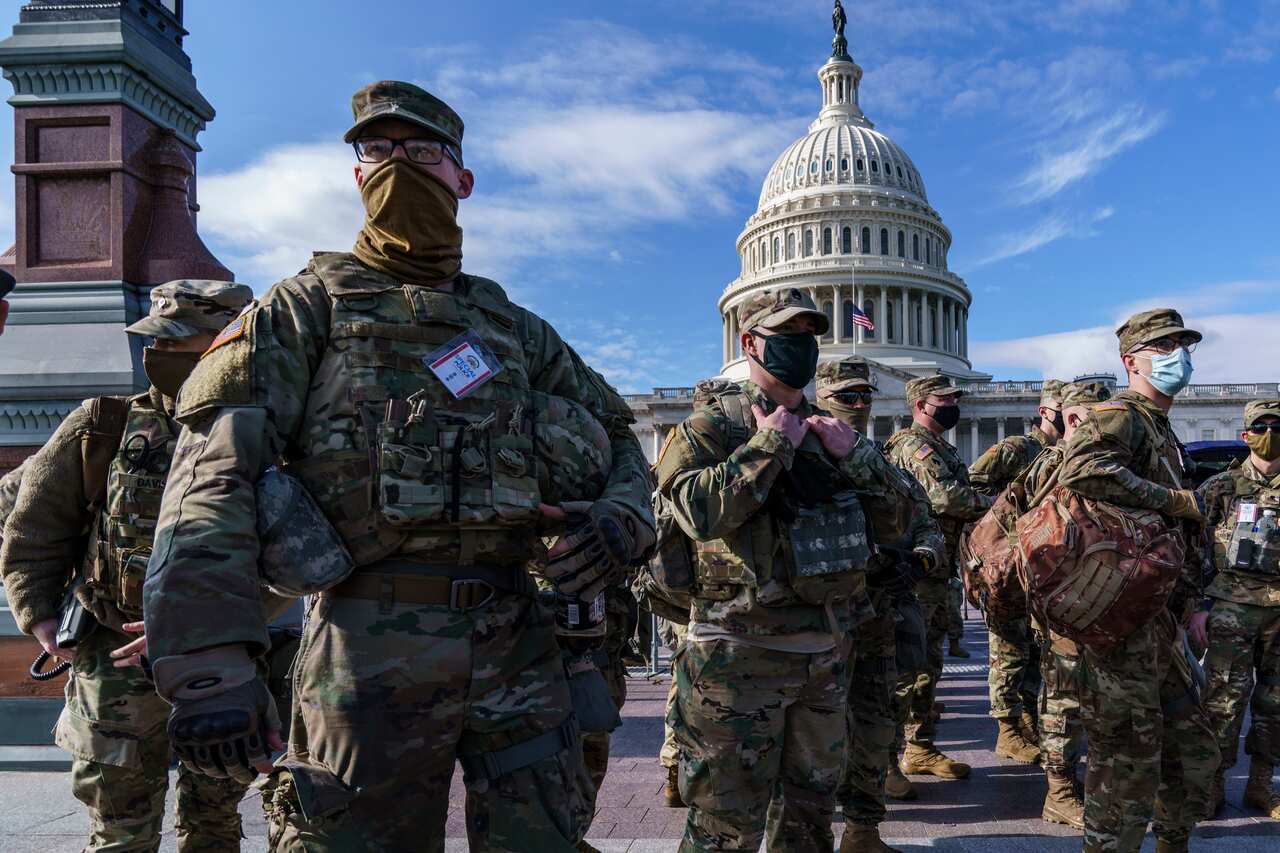 A dozen National Guard troops have been removed over right-wing militia ties.