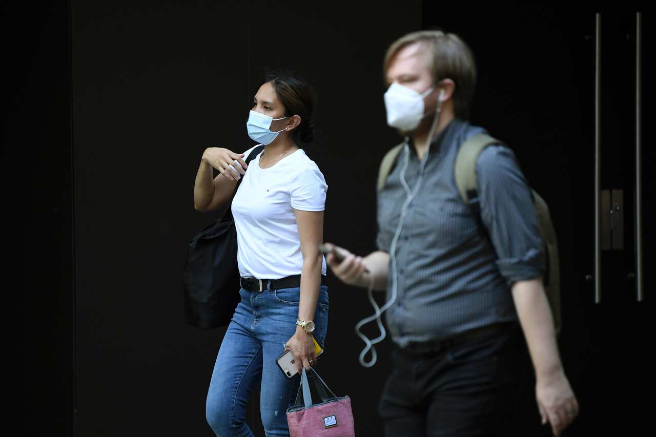Pedestrians wearing a face mask in Sydney, Monday,  January 18, 2021. NSW reported six new local cases of COVID-19 on Sunday, five of which were household contacts of a previously-confirmed case in western Sydney. (AAP Image/Joel Carrett) NO ARCHIVING