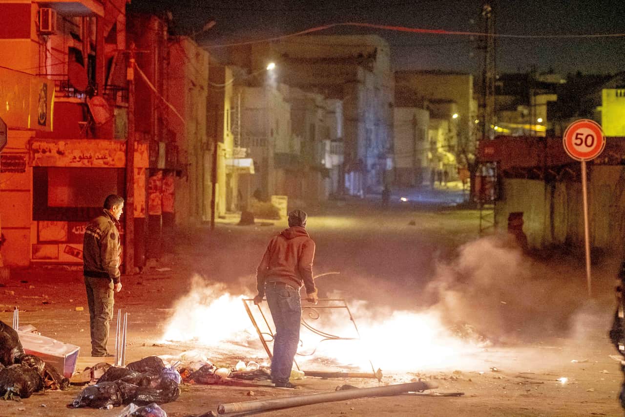 In Ettadhamen, a working-class suburb west of Tunis, clashes are sporadic, young people burn trash cans and stone the police who respond with tear gas.