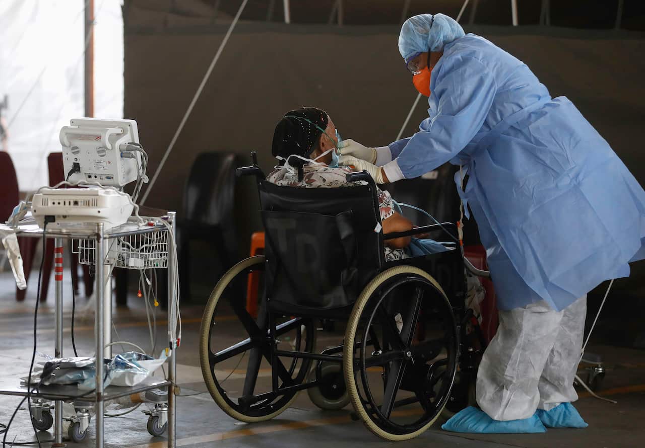 A healthcare worker provides oxygen to a patient at the Steve Biko Academic Hospital in Pretoria, South Africa, Tuesday 19 January, 2021. 