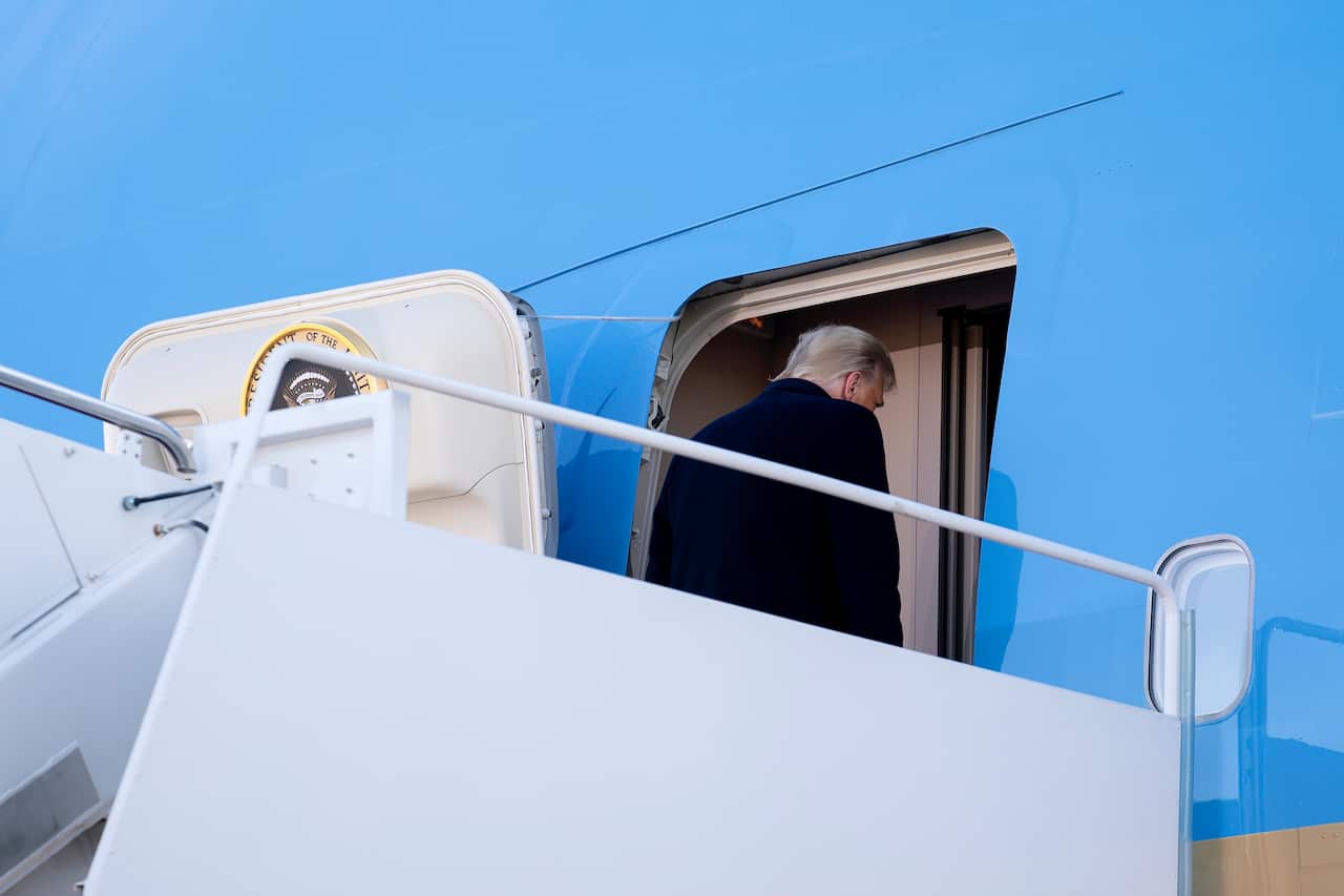 US President Donald Trump boards Air Force One during a farewell ceremony at Joint Base Andrews, Maryland.