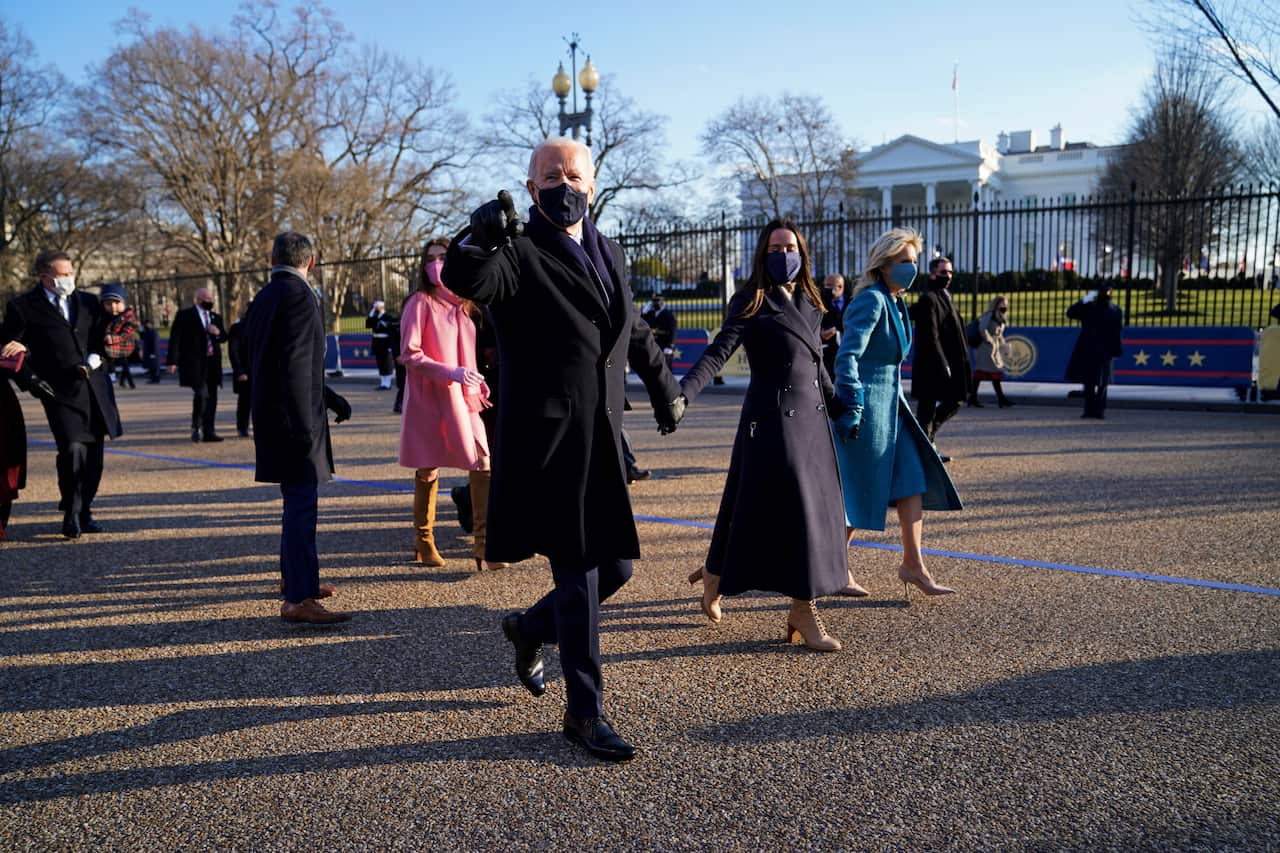 President Joe Biden and his family walk towards the White House.            