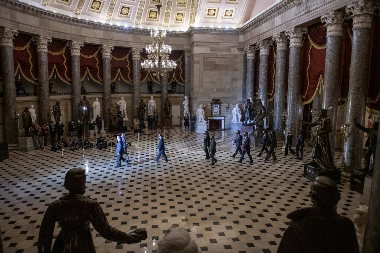 The impeachment managers walk through Statuary Hall to deliver the articles of impeachment against Donald Trump to the Senate on Monday, 26 January.