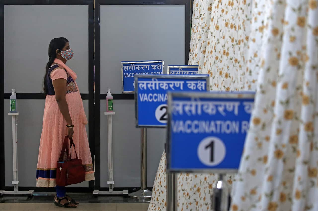 A woman waits to receive a COVID-19 vaccine shot at Shatabdi Hospital in Mumbai, India on 30 January.