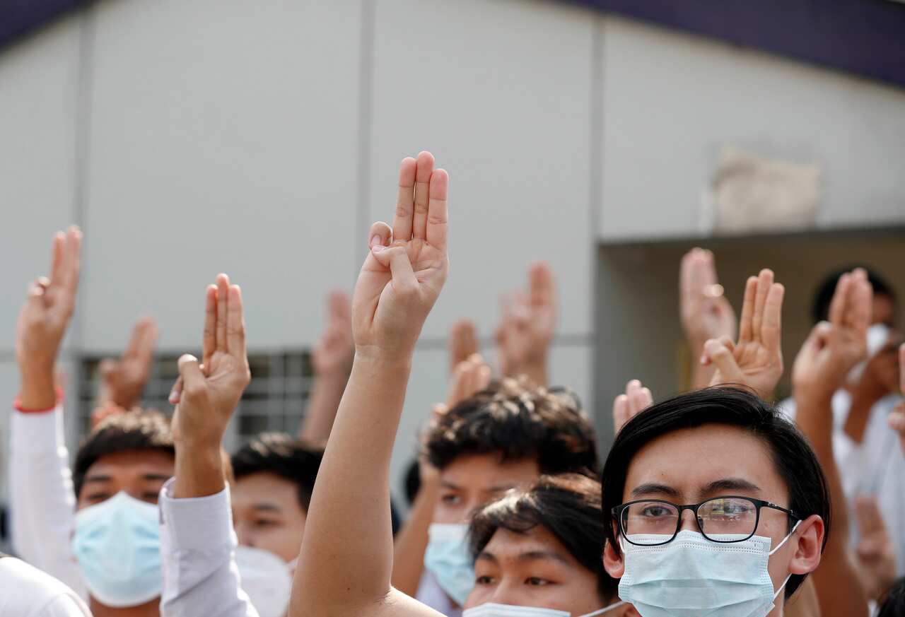 Teachers and students of Myanmar Mercantile Marine College flash three-finger salutes as they protest against the military coup in Yangon