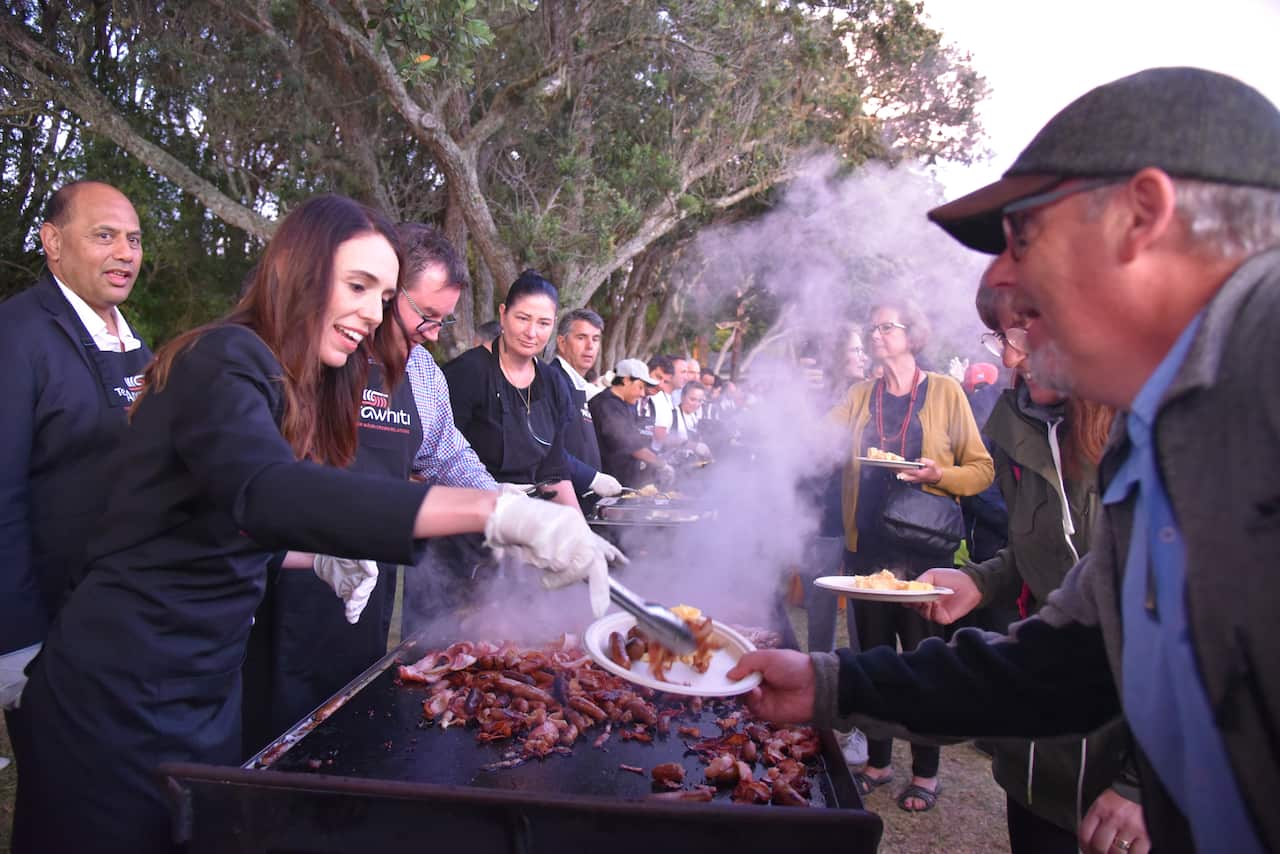New Zealand Prime Minister Jacinda Ardern and members of her government serve Kiwis a free barbecue breakfast at Waitangi on Saturday, February 6, 2021.