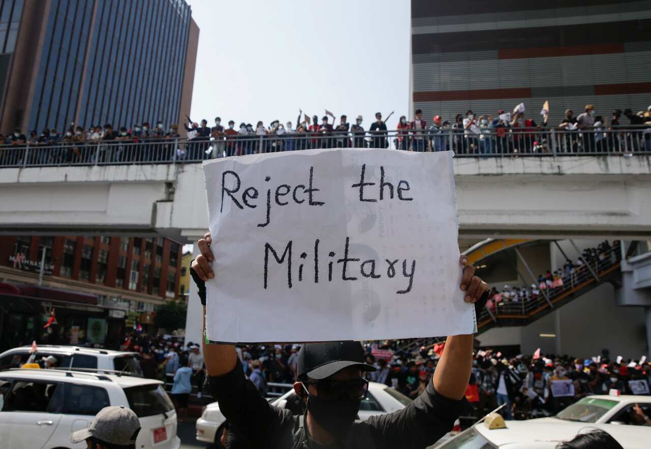 A demonstrators holds a placard reading 'Reject The Military' during a protest against the military coup at downtown area in Yangon, Myanmar.