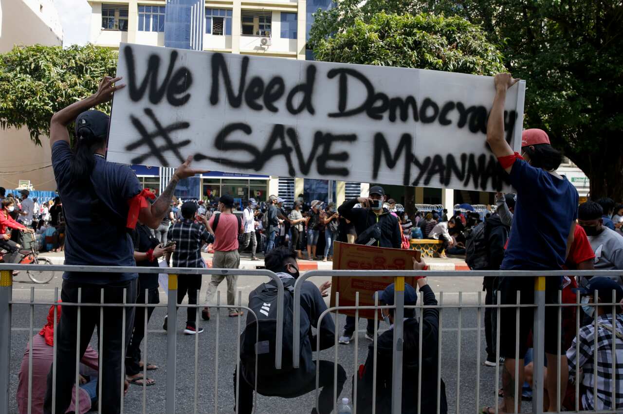 Demonstrators hold a banner during a protest against the military coup at downtown area in Yangon, Myanmar.