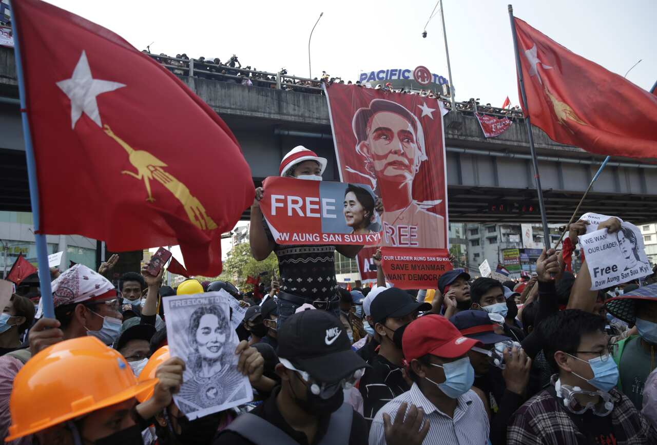 Demonstrators hold banners calling to free Aung San Suu Kyi during a protest against the military coup in Yangon