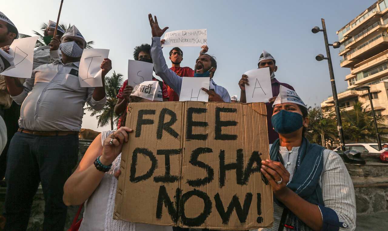 Activists of Aam Aadmi Party carry placards and shout anti government slogans during a protest demanding the release of Indian climate activist Disha Ravi