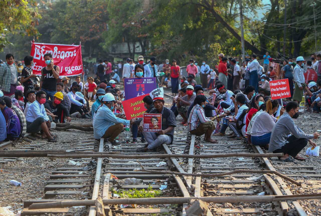Protesters sit on railway tracks to disturb trains in Mandalay