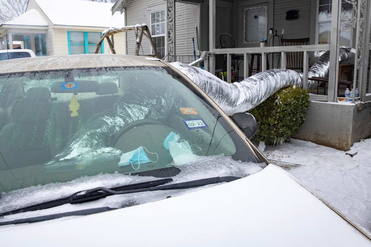 A couple using their car to heat their home in East Dallas on Wednesday, Feb 17, 2021.