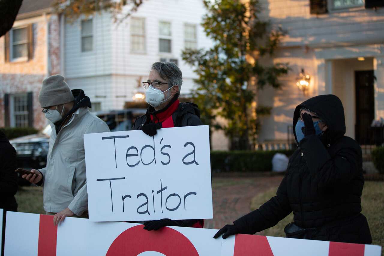 Demonstrators stand in front of US Senator Ted Cruz's home demanding his resignation, Thursday, Feb 18, 2021, in Houston