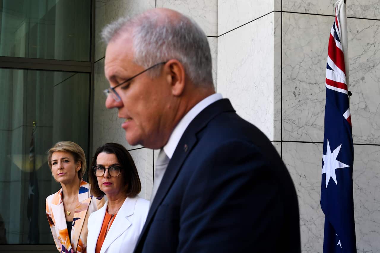 Social Services Minister Anne Ruston and Employment Minister Michaelia Cash listen to Prime Minister Scott Morrison on Tuesday