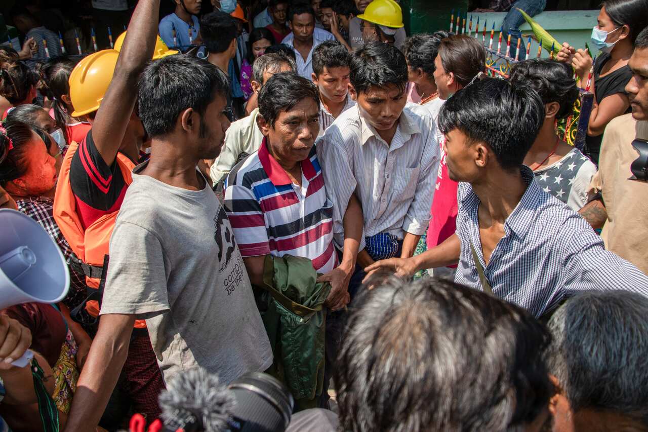 Residents arrest military supporters during the rally on Thursday.