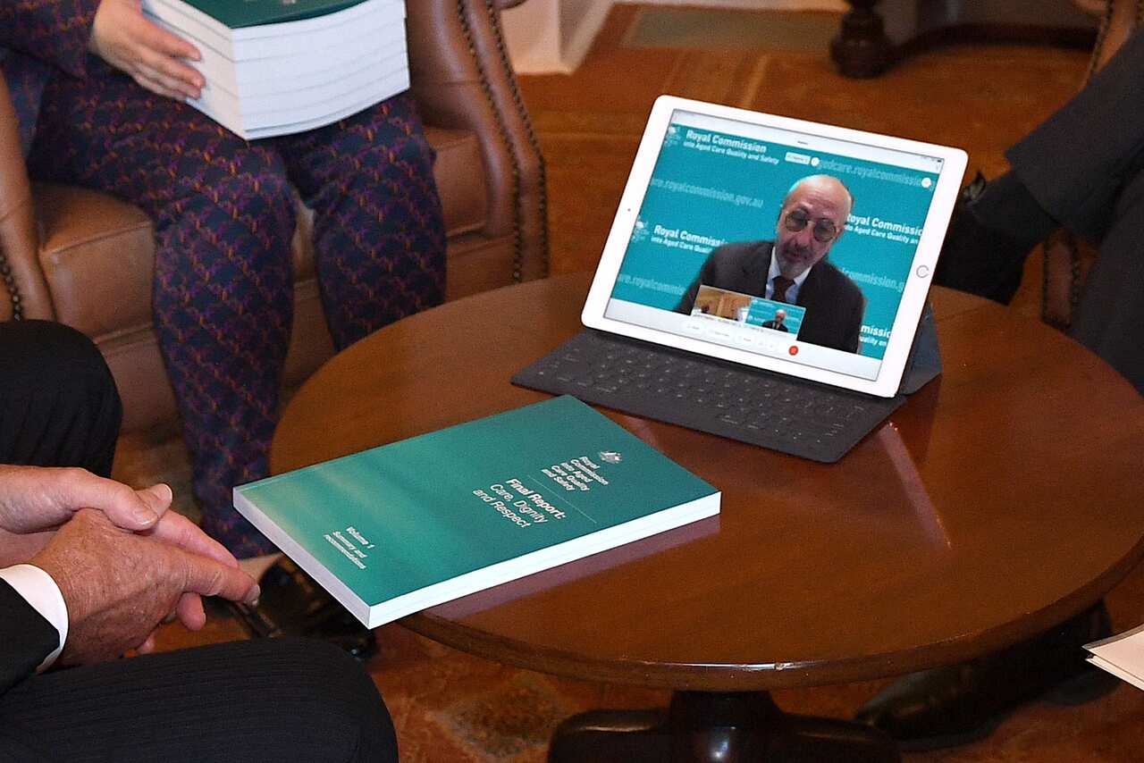 The final report of the aged care royal commission is seen as commission chair Tony Pagone speaks to Governor General David Hurley via video link on Friday.