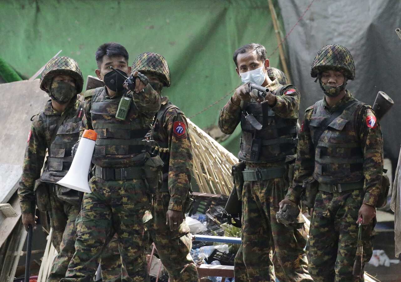 Soldiers advance to disperse protesters during a protest against the military coup in Yangon, Myanmar, 3 March 2021.
