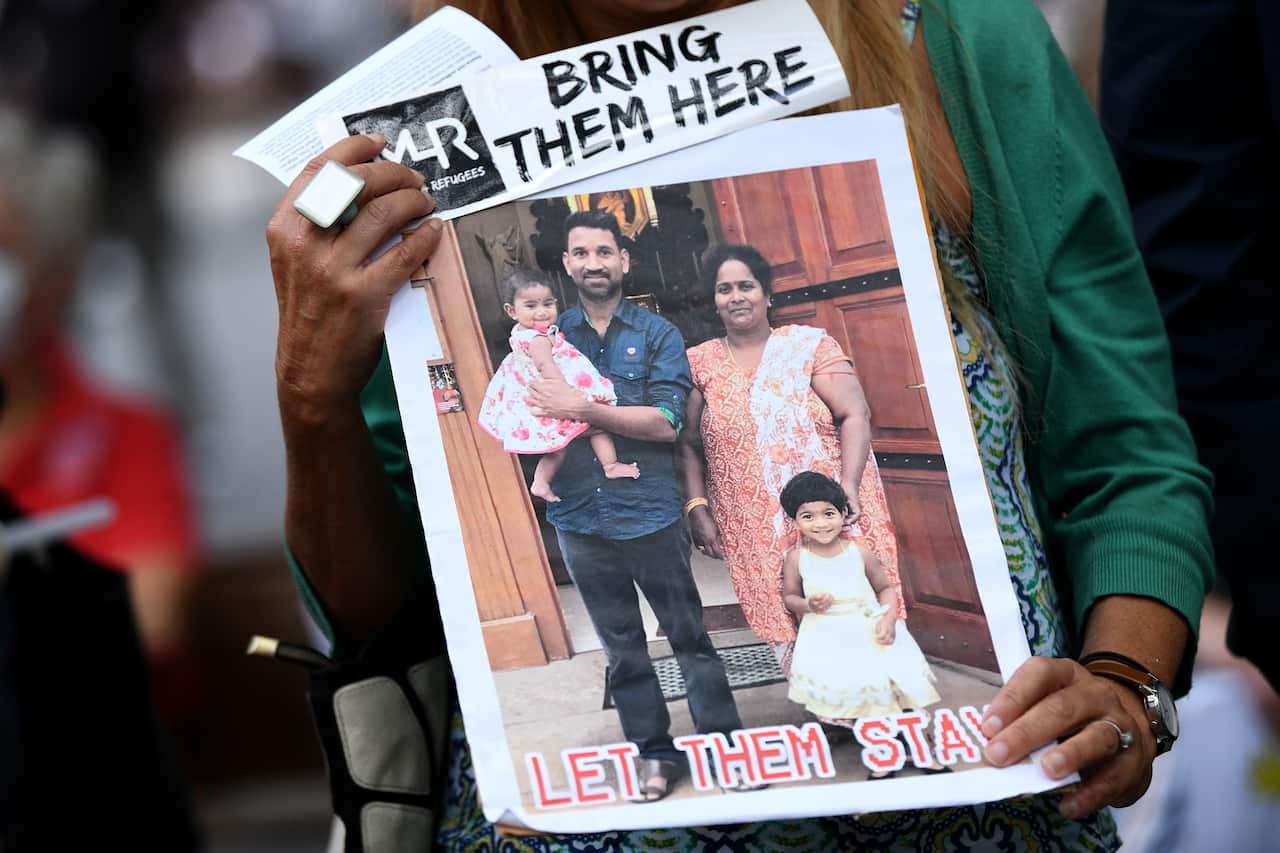 Placards are seen during a vigil in support of the Tamil family, in Sydney on 5 March, 2021. 