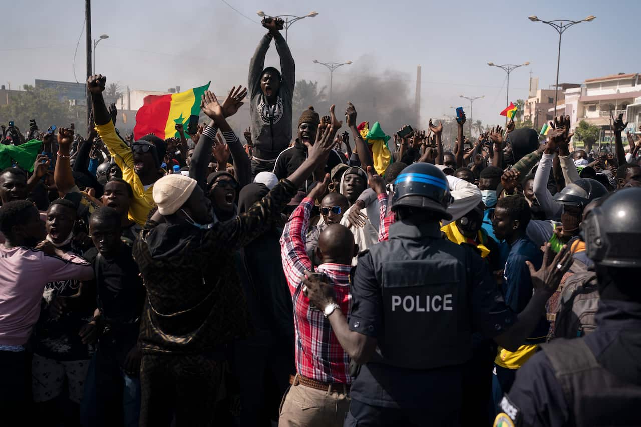 Demonstrators shout slogans in front of police during a protest against the arrest of opposition leader Ousmane Sonko, Senegal, 8 March, 2021. 