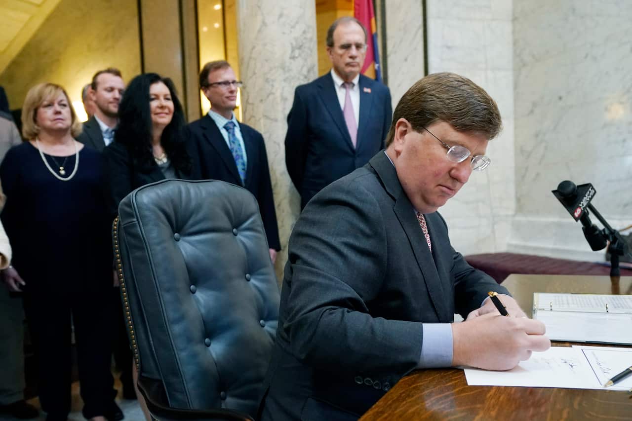 Mississippi Governor Tate Reeves signs the first state bill in the US this year to ban transgender athletes from competing in female sports, March 11, 2021