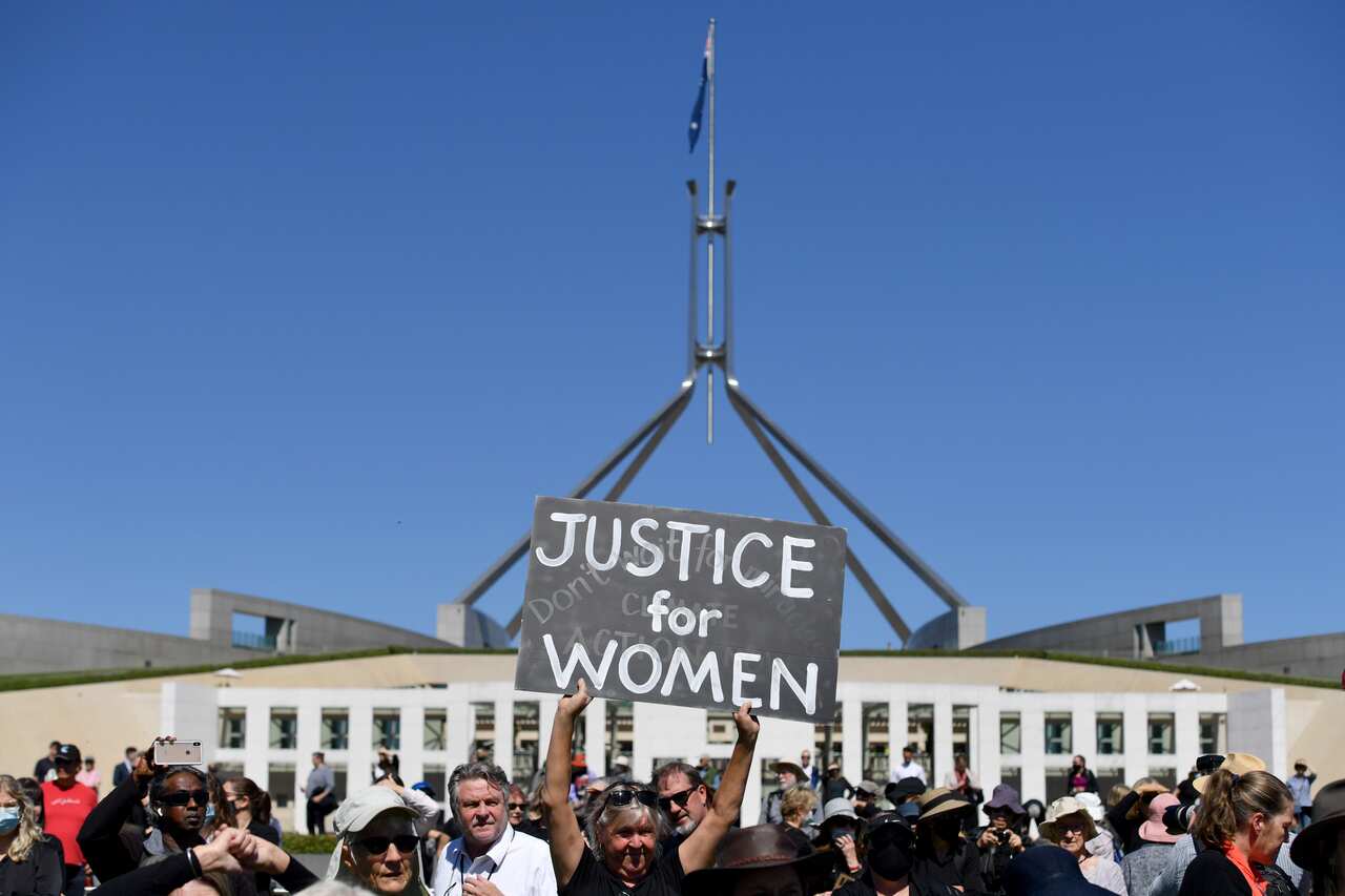 A protesters holds a placard during the Women's March 4 Justice in Canberra on Monday.
