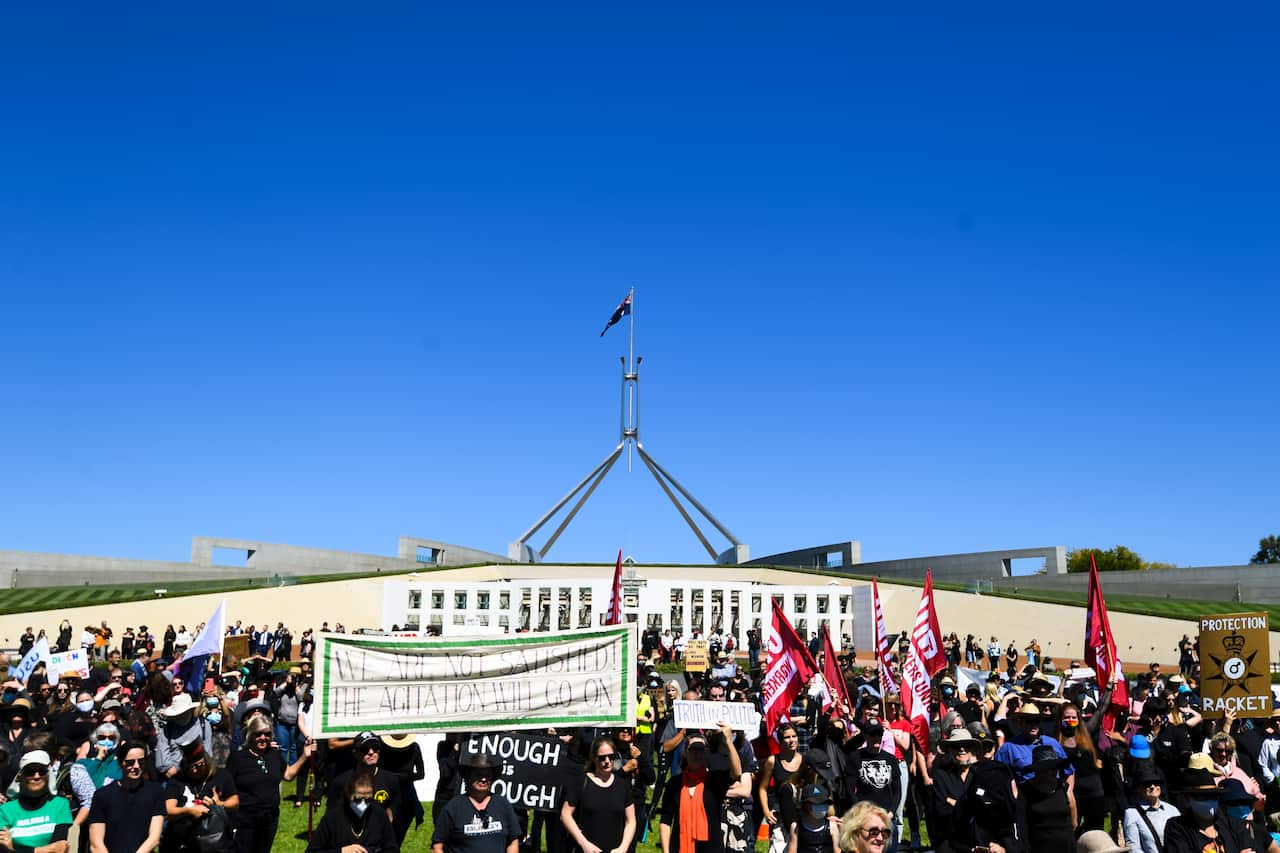 Protesters attend the Women's March 4 Justice in front of Parliament House in Canberra on Monday.