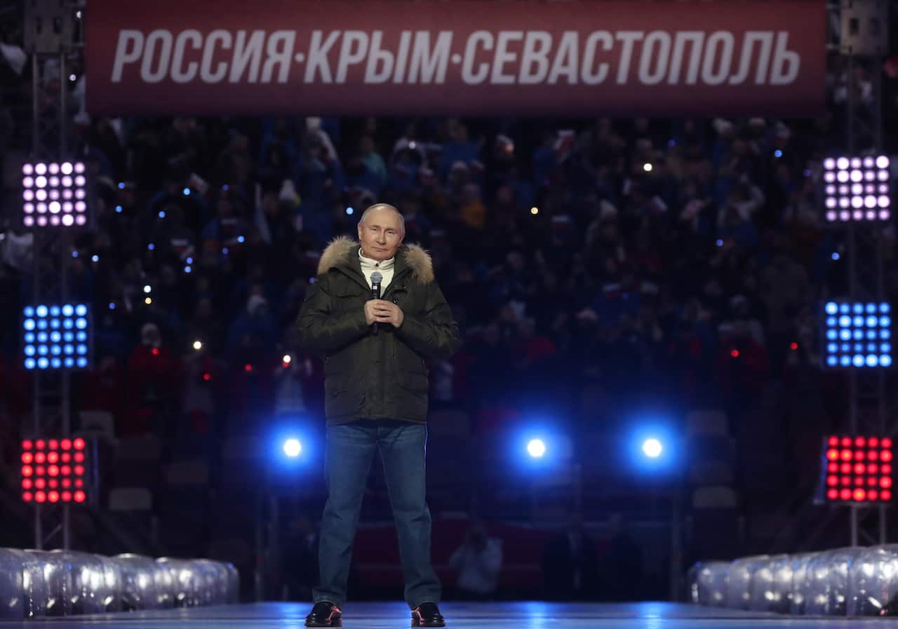 President Vladimir Putin at a concert for the 7th anniversary of the annexation of Crimea. Russia’s involvement in Ukraine has killed 14,000 people since 2014.