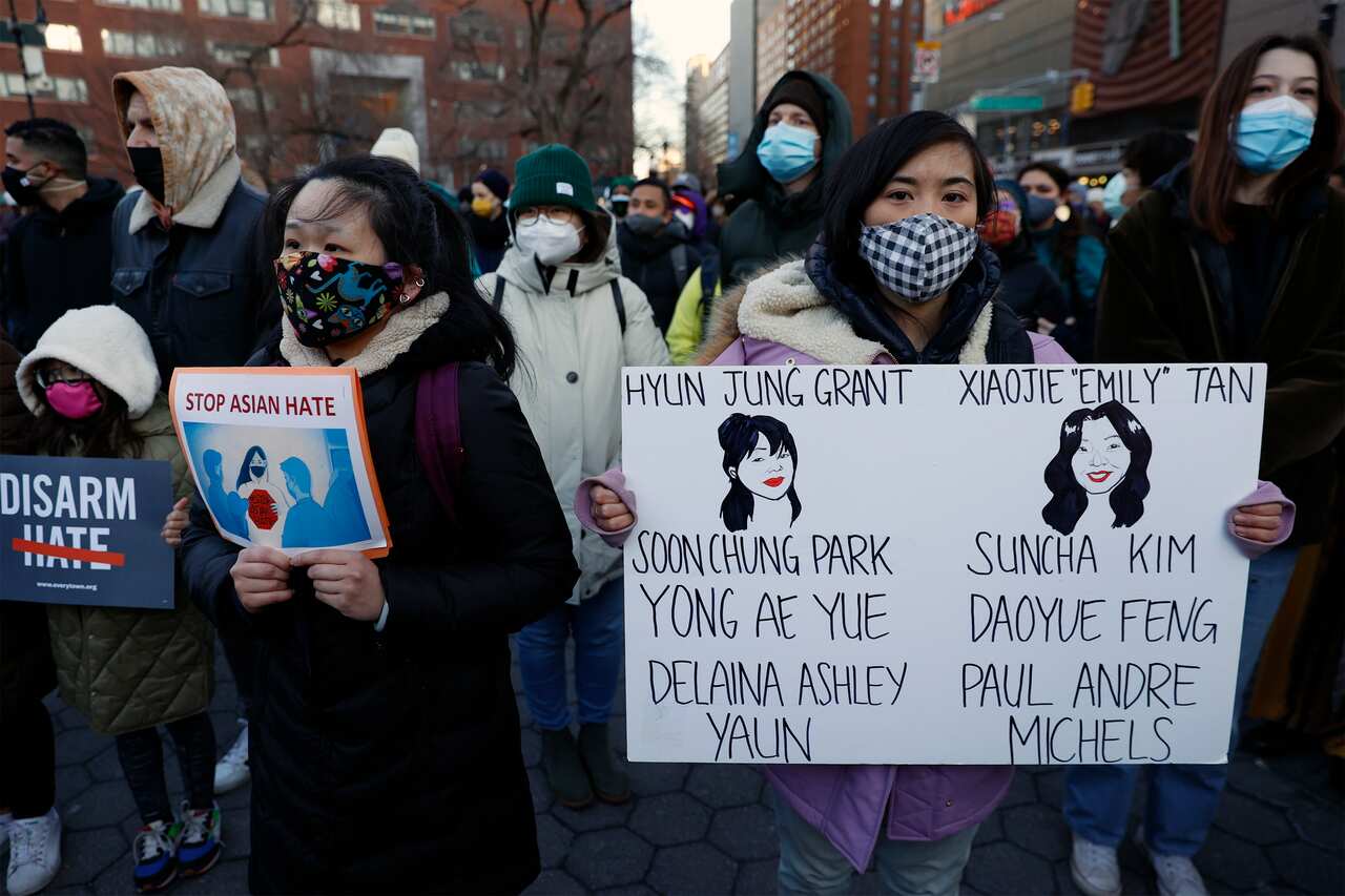 People hold up signs during a Vigil for Peace, organised by the Asian American Federation, in Union Square in New York City, New York, USA, 19 March 2021.