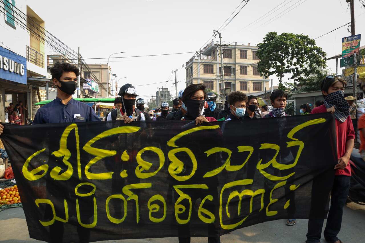 Demonstrators march during a protest against the military coup in Mandalay, Myanmar, on 20 March.