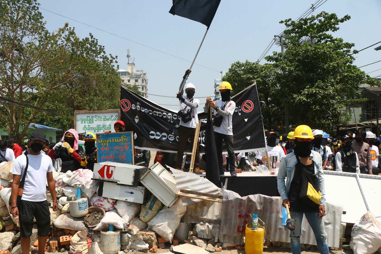 Protesters prepare to defend themselves as they gather in Yangon, Myanmar, on Saturday, 20 March.