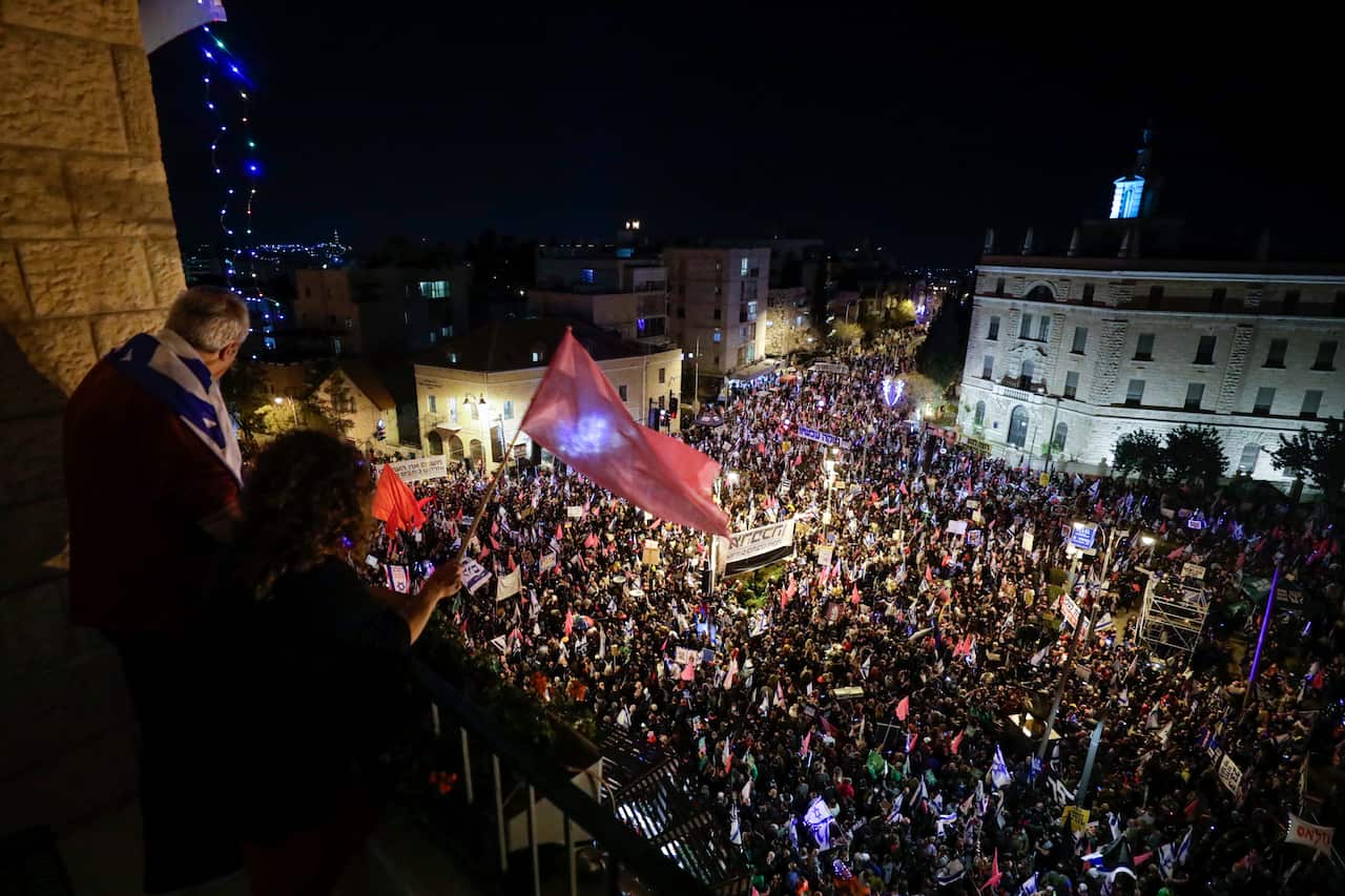 Thousands of protesters chant slogans during a protest against Israel's Prime Minister Benjamin Netanyahu outside his residence in Jerusalem, March. 20, 2021.