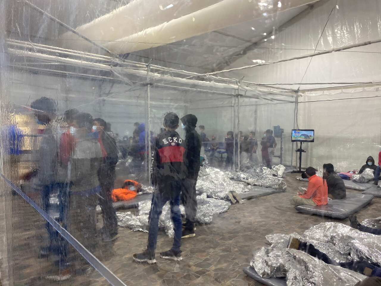 Immigration detainees in the CBP temporary overflow facility in Donna, Texas
