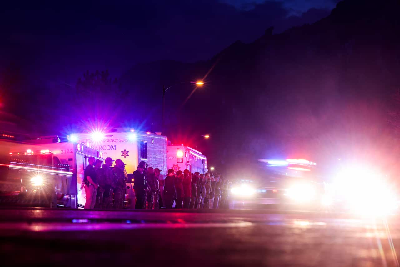 Vehicles escort the body of a slain police officer from the scene of a shooting in Boulder Colorado on March 22. 2021.