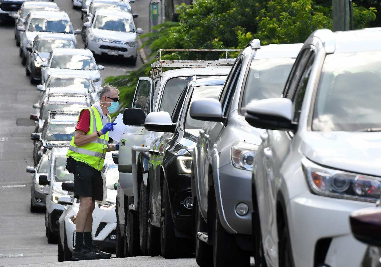 Brisbane residents queue to be processed through a drive-in COVID-19 testing site at Bowen Hills in Brisbane on 29 March, 2021. 