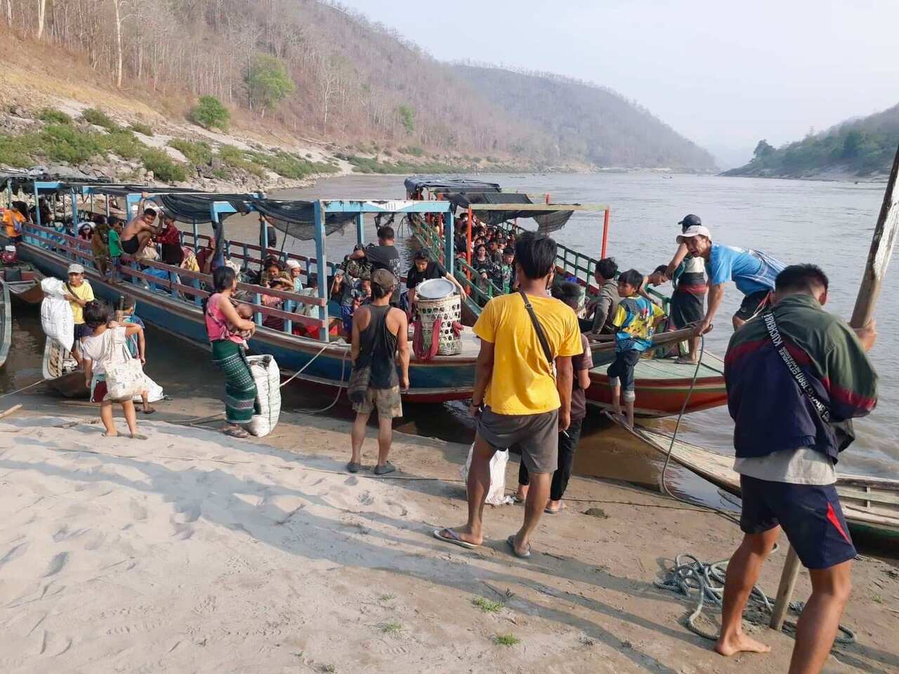 Refugees from Myanmar are pictured in northwestern Thailand on March 29, 2021, after crossing the border by boat to flee airstrikes by the military.