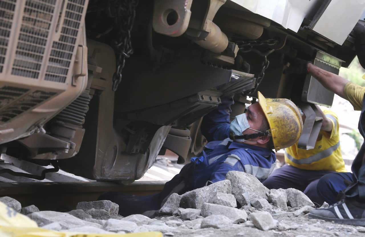A rescue worker climbs out from a part of the derailed train near Taroko Gorge in Hualien, Taiwan on Saturday, April 3, 2021