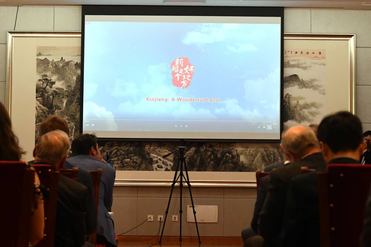 Journalists watch the screen during China’s Ambassador to Australia Cheng Jingye’s press conference at his residence in Canberra. Wednesday, April 7, 2021. (AAP Image/Mick Tsikas) NO ARCHIVING