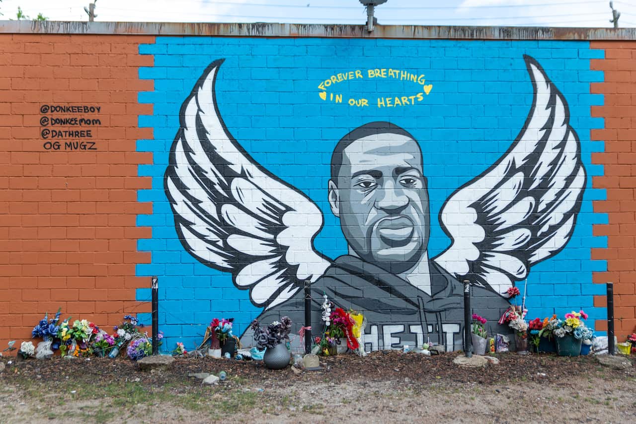People continue to lay flowers at the George Floyd Mural in Third Ward, Houston, TX, where Floyd grew up.