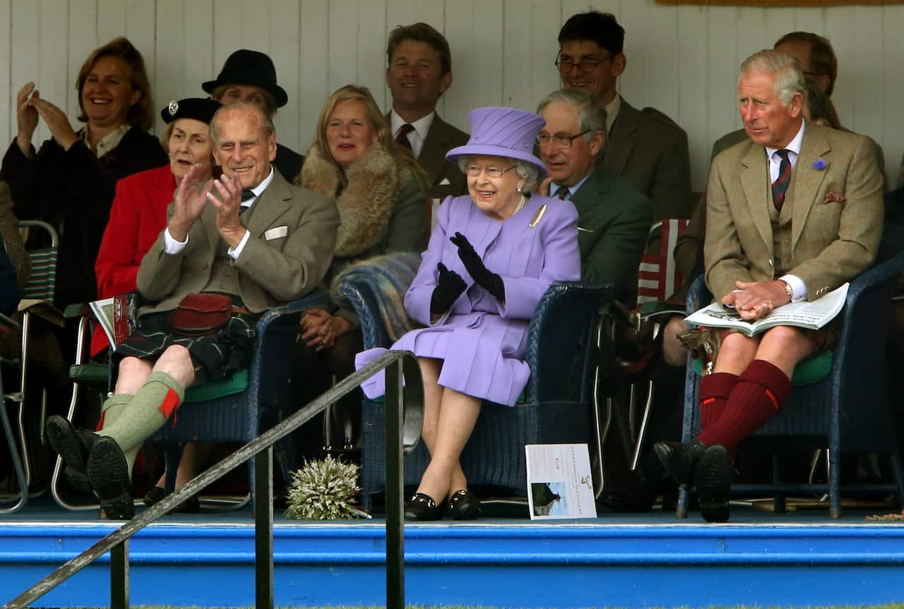  Queen Elizabeth II, accompanied by the Duke of Edinburgh and the Prince of Wales attending the Braemar Royal Highland Gathering.