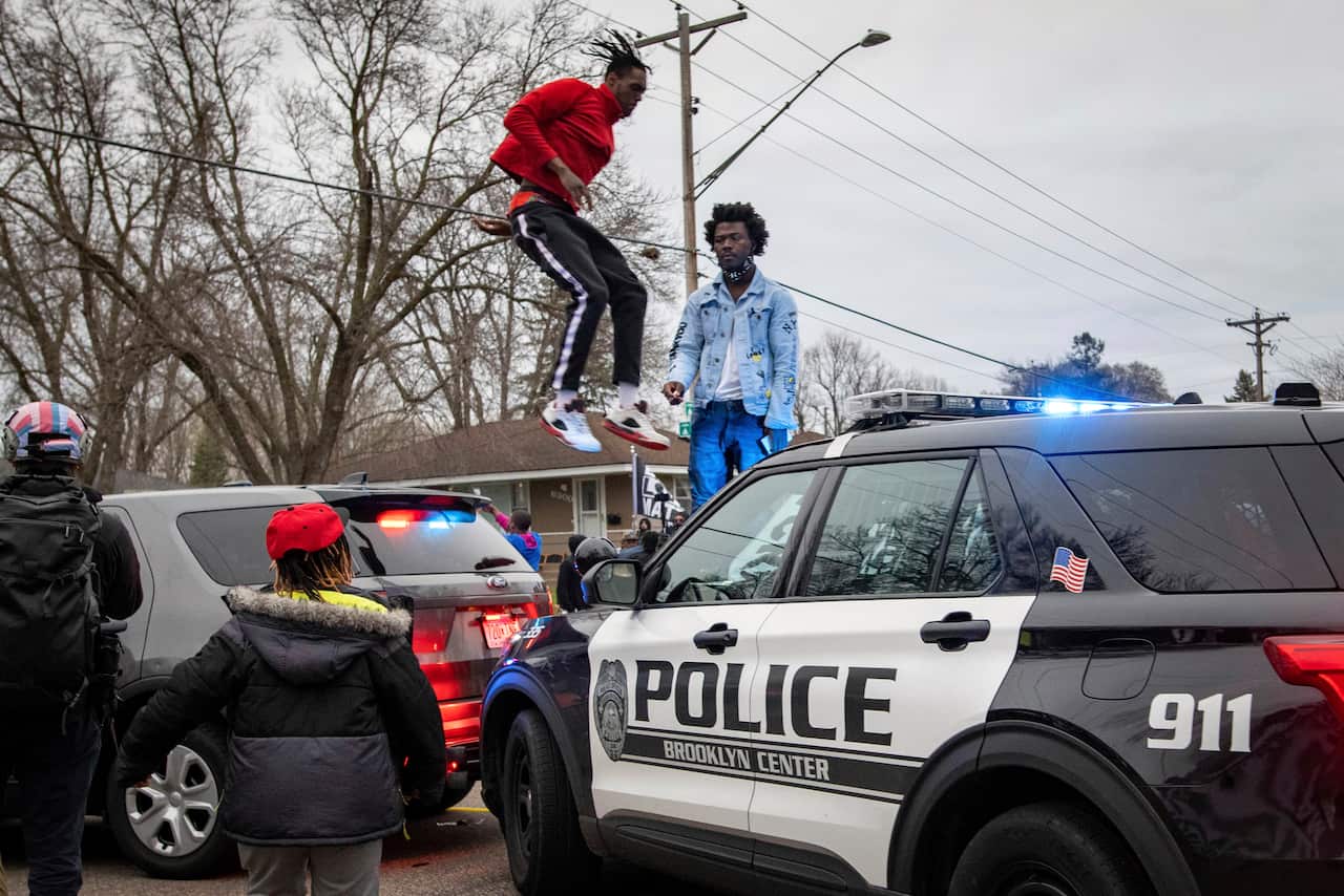 Protesters clash with police after a man was shot and killed by local law enforcement in Brooklyn Center, Minn.