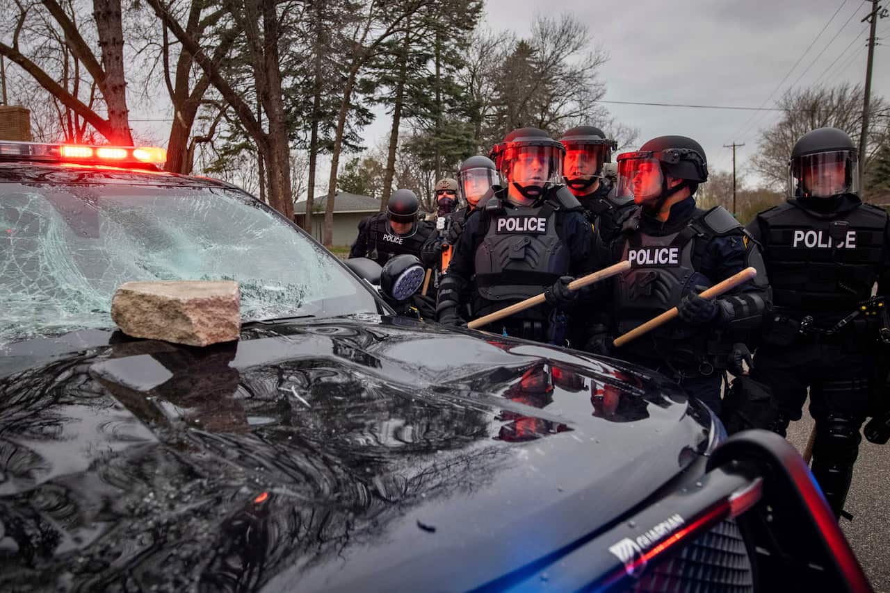 Protesters clash with police after a man was shot and killed by local law enforcement on Sunday April 11, 2021, in Brooklyn Center, Minn.  