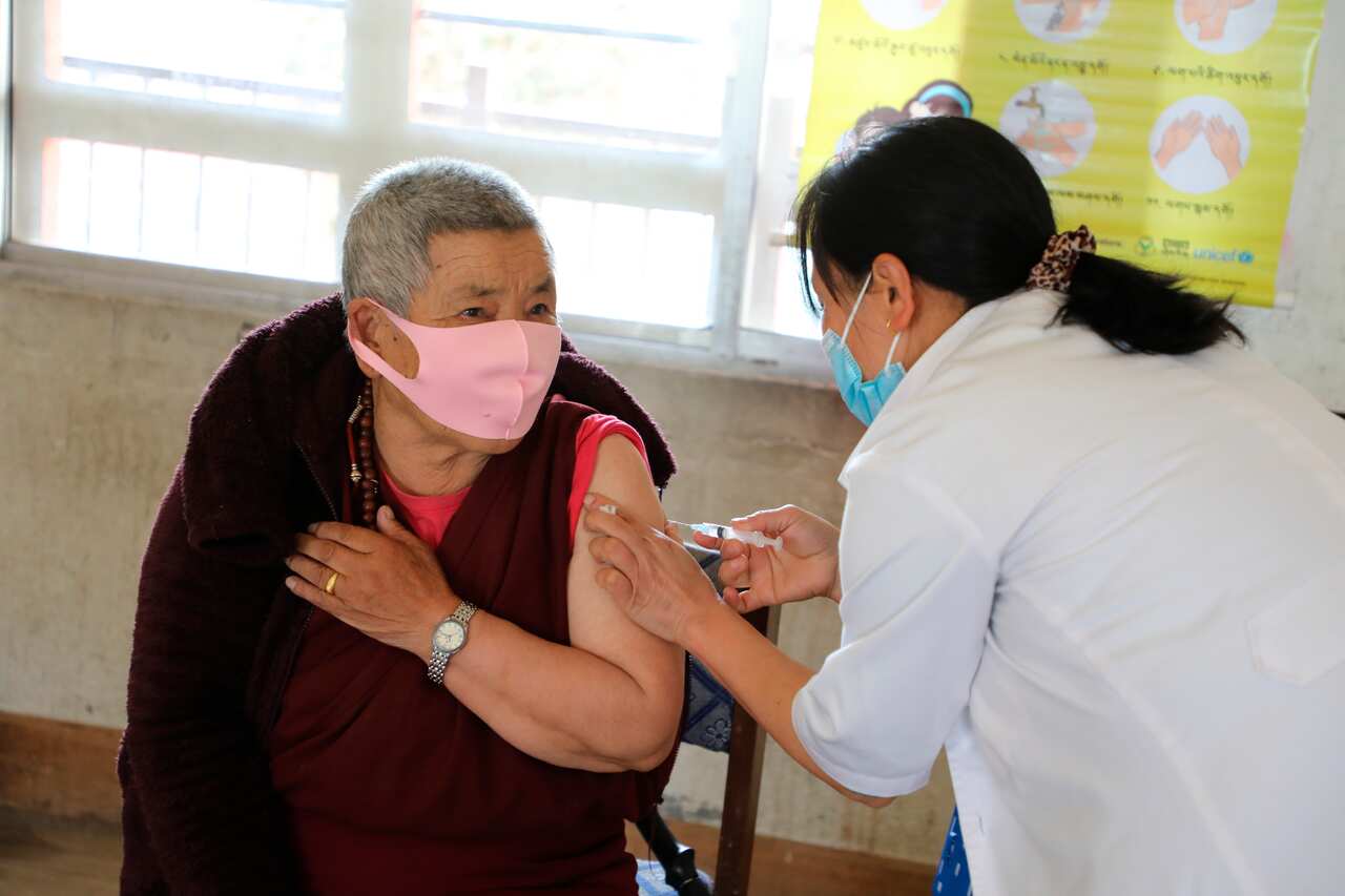 A health worker administers COVID-19 vaccine to a man at a health centre in Thimpu, Bhutan, Sunday, March 28, 2021
