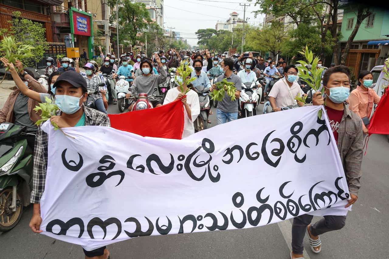 Demonstrators carry a banner during an anti-military coup protest in Mandalay, Myanmar, on 17 April, 2021. 