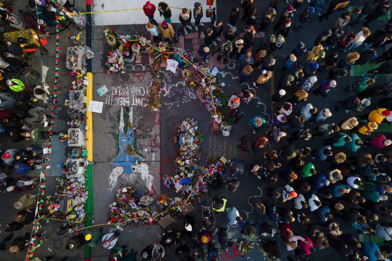 A crowd gathers next to the spot where George Floyd was murdered after the guilty verdict was announced.