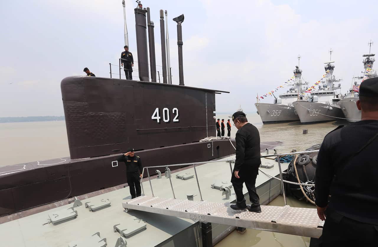 A crew of Indonesian Navy submarine KRI Nanggala as an officer walks aboard, at base of the Eastern Fleet Command in Surabaya, East Java, Indonesia