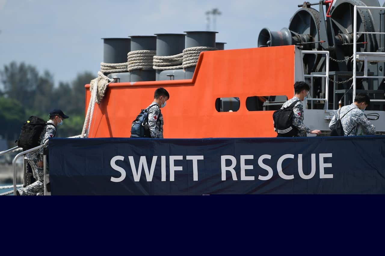Republic of Singapore Navy personnel board the MV Swift Rescue to aid the search for missing Indonesian submarine KRI Nanggala-402, from Singapore, on 21 April.
