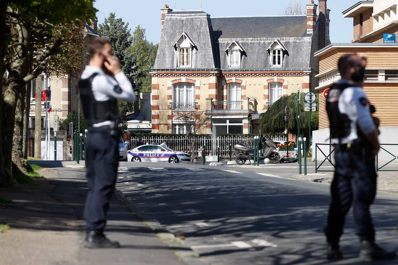French police officers secure the street near the Police Station in Rambouillet, France, 23 April 2021, following a knife attack.